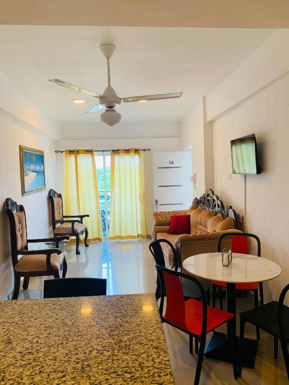 a living room with a couch and a table and chairs at Plataview Apartahotel apt 3A in Monte Plata