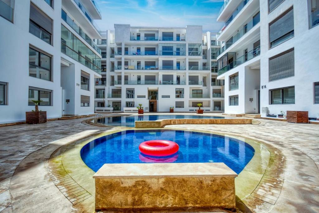 an apartment pool with a red frisbee in the middle at Serenity - Appart Piscine - 4-5p in Agadir