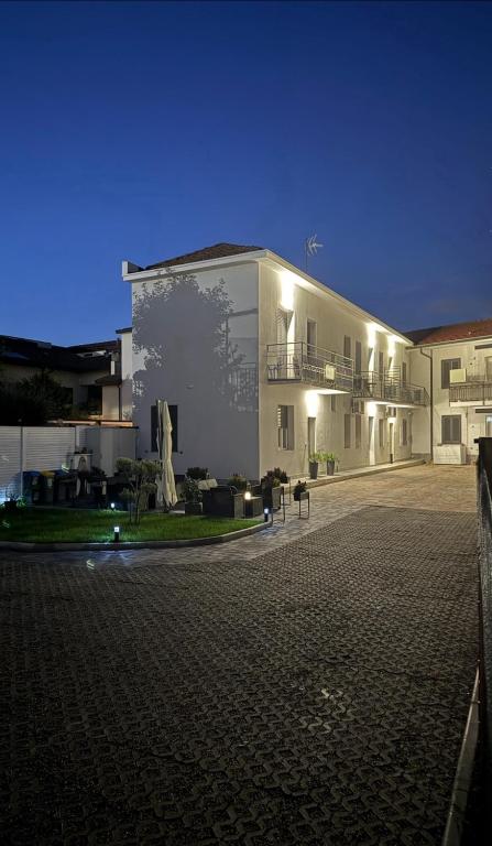 a large white building with a courtyard at night at Bala Dream House in Verano Brianza