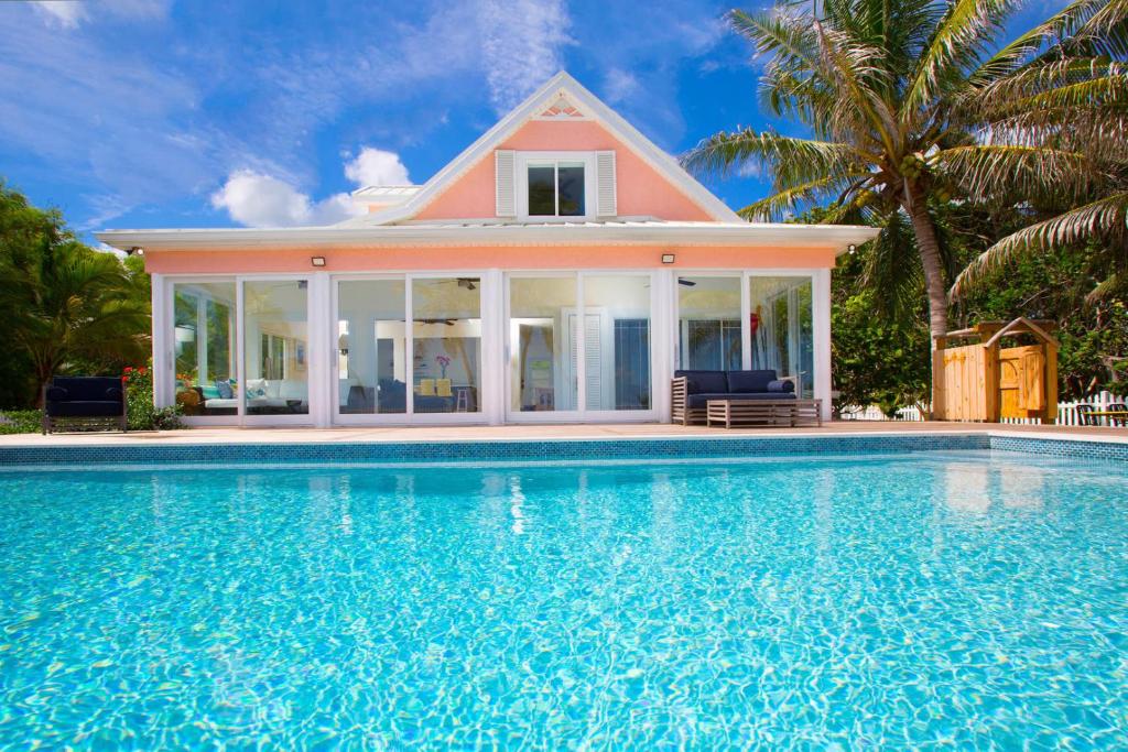 a house with a swimming pool in front of a house at Babylon Reef in North Side