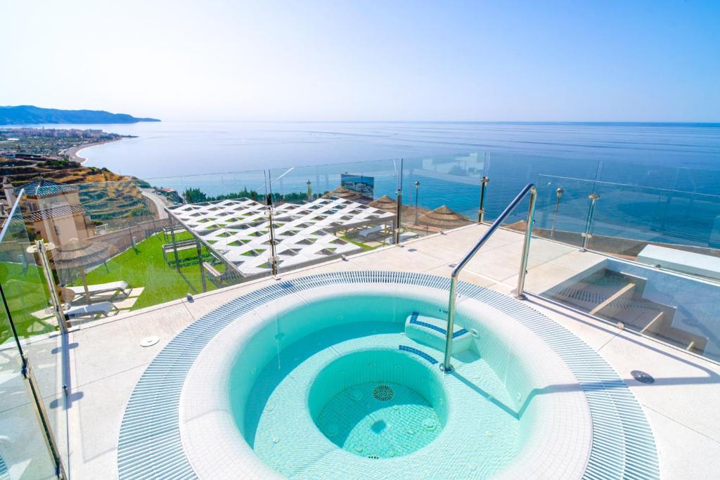 a hot tub on top of a building with the ocean at Bayview Hills Suite by Casasol in Torrox
