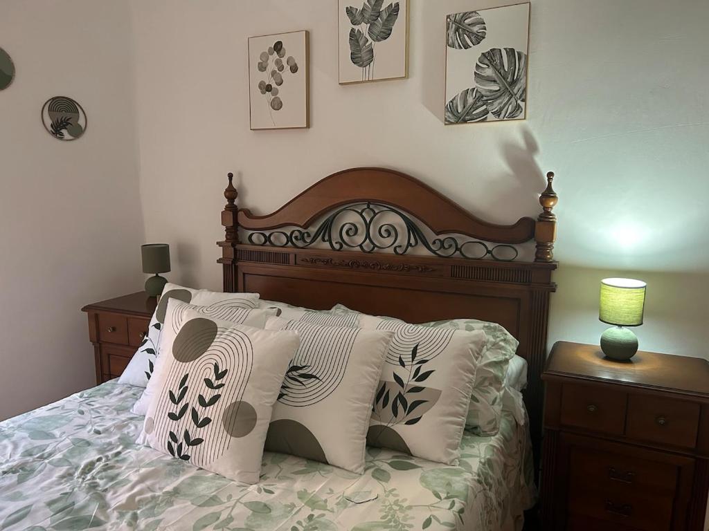 a bedroom with a bed with pillows on it at La villa de Leo y Lola in Frómista