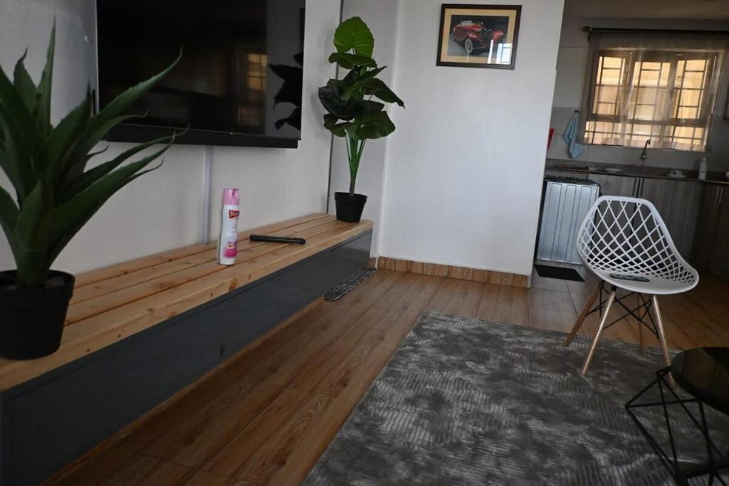 a living room with a table and a chair at Milele Homes- Ruaka View Aprt in Nairobi