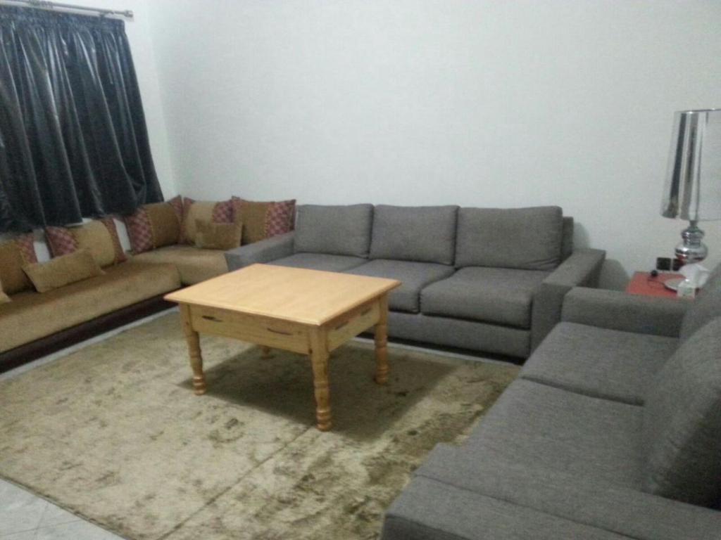 ein Wohnzimmer mit einem Sofa und einem Couchtisch in der Unterkunft Appartement en plein centre ville in Fès