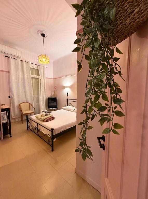 a bedroom with a bed and a room with a table at Classic rooms in the center in Loutraki