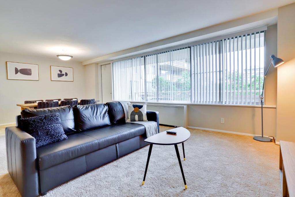 a living room with a couch and a table at Modern Apt in Prime Location w Business Facilities in Addison Heights