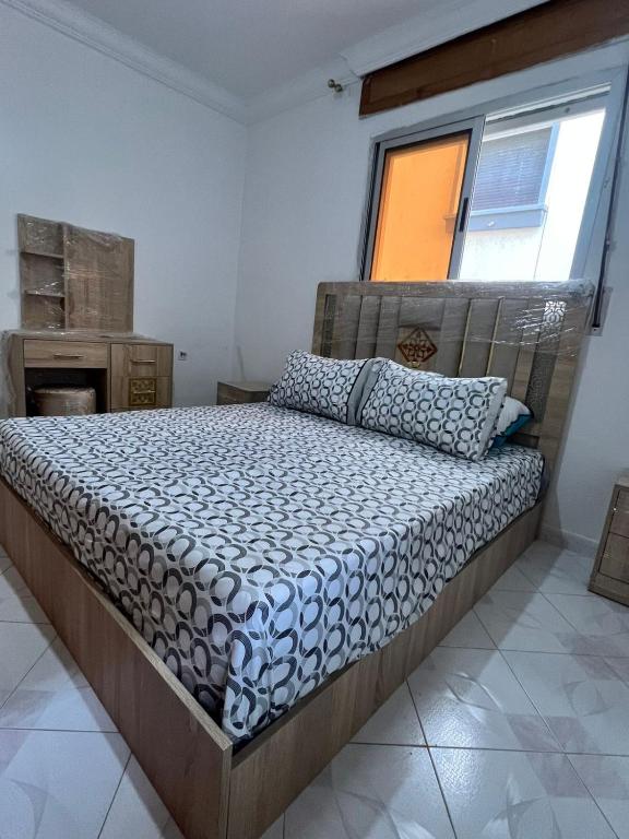 a bedroom with a bed in a room with a window at Casa youssef 2 in Asilah