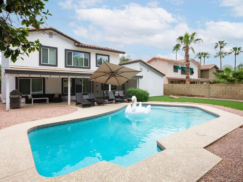 a swan in a swimming pool in front of a house at Sereno - Sparkling Pool - Near Scottsdale Quarter in Phoenix