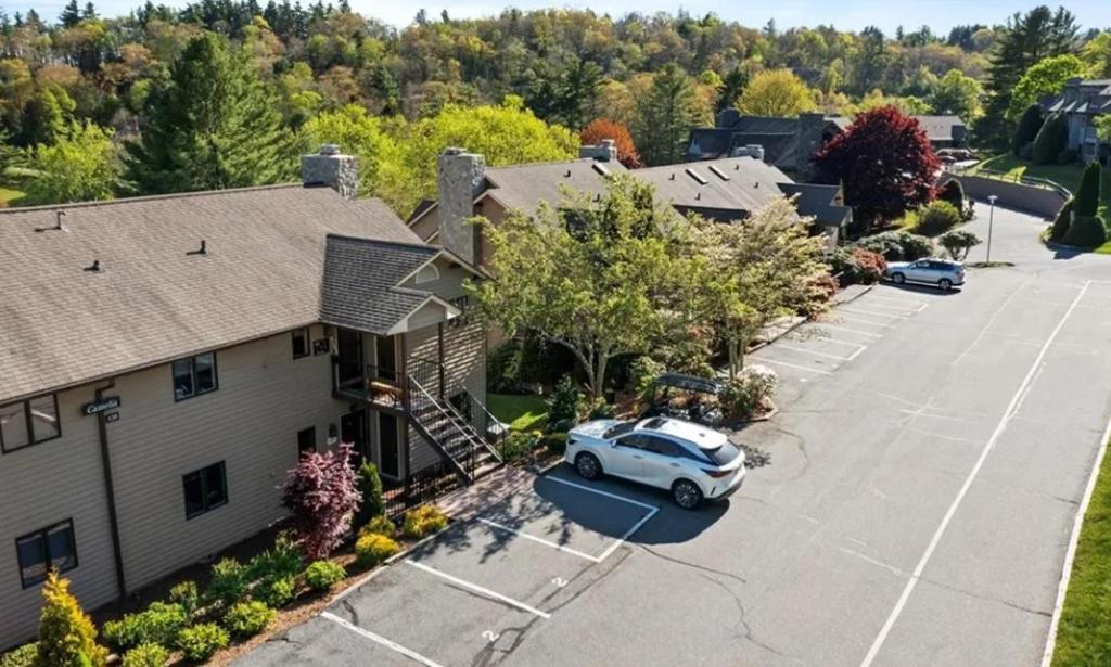 an aerial view of a house with a car parked in a parking lot at Chetola: Camelia 2 in Blowing Rock