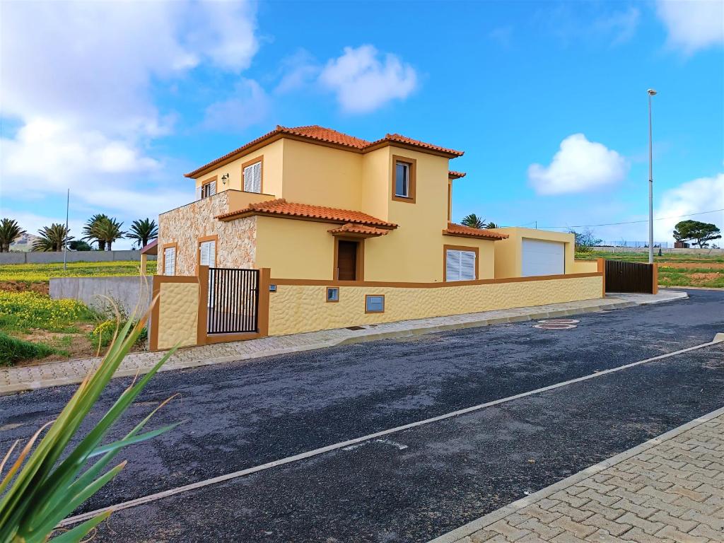a yellow house on the side of a road at La Maison Dorée in Porto Santo