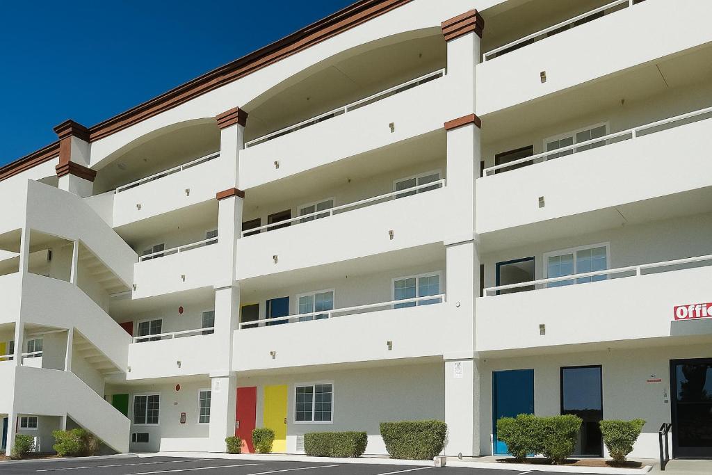 an exterior view of a white apartment building at Border Plaza Hotel in San Diego