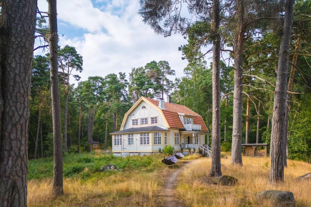 a house in the woods with trees at Stay North - Honkala in Turku