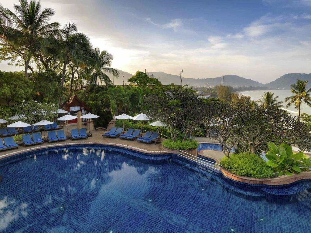 a pool at a resort with a view of the water at Novotel Phuket Resort in Patong Beach