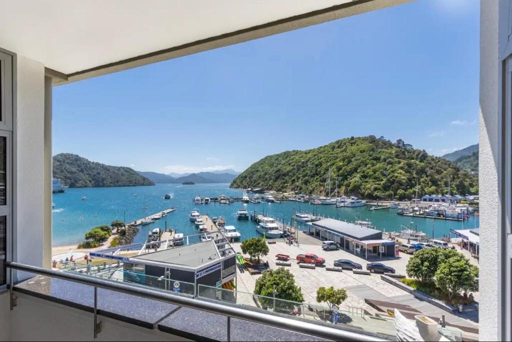 a balcony with a view of a marina at picton beach view apartment in Picton
