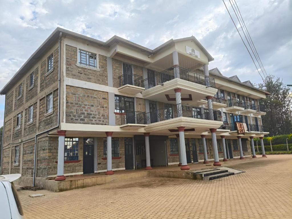 a large brick building with a balcony on it at Mango Plaza in Homa Bay