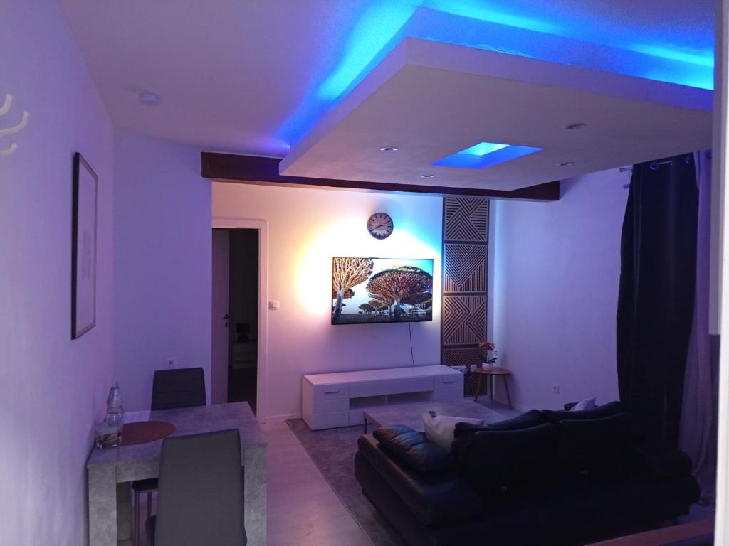 a living room with blue lights on the ceiling at Badoumkassa in Welkenraedt