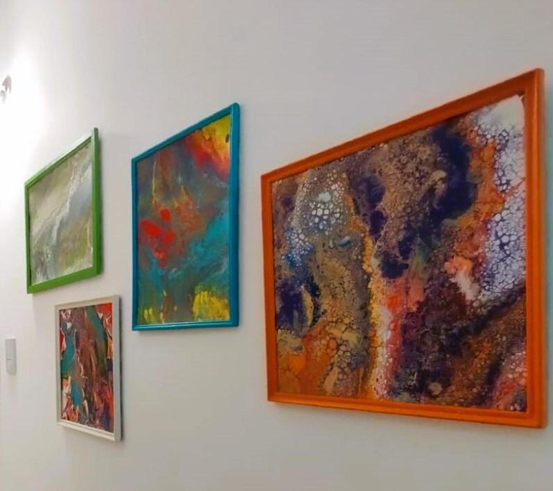 a group of paintings hanging on a wall at Catalina - Excelente ubicacion en pleno centro - 1B in Santa Fe