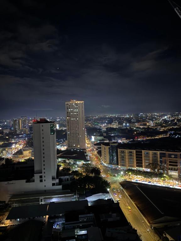 a city lit up at night with buildings at Avida Towers Davao Condotel in Davao City