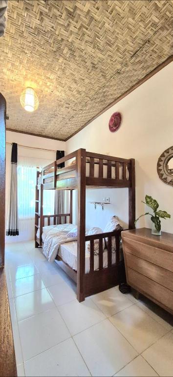 a bedroom with a wooden bunk bed in a room at Elisa Hostel in Kuta Lombok