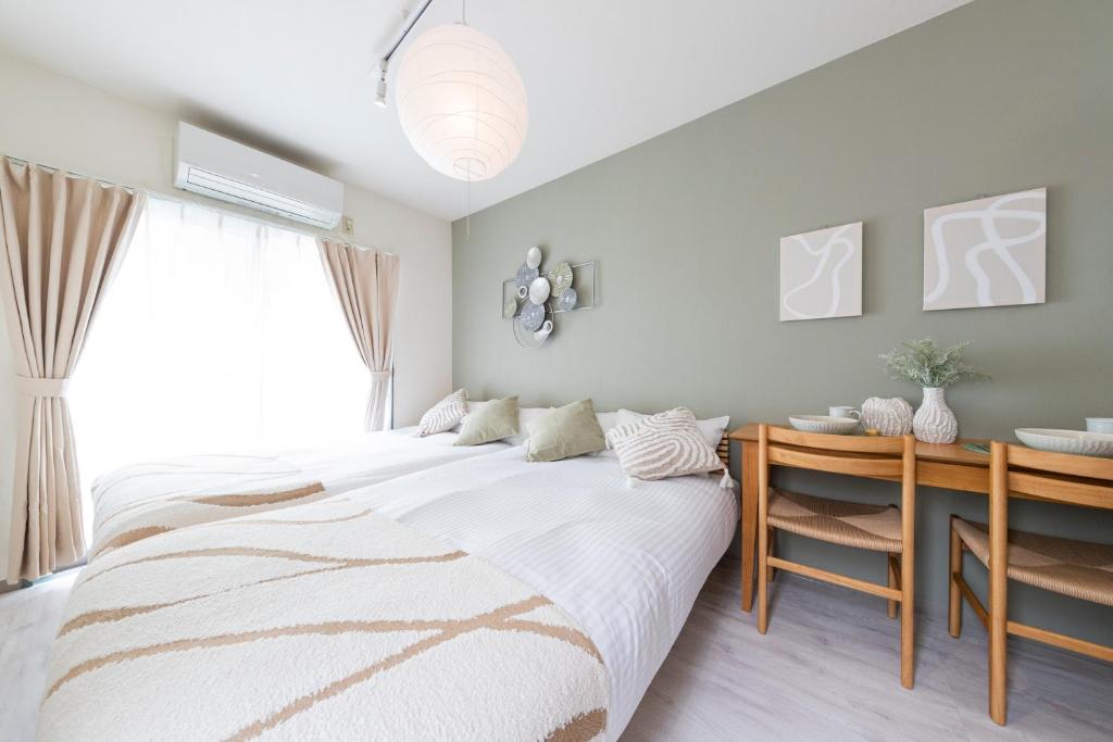 Postel nebo postele na pokoji v ubytování Shinjuku Homely Stay