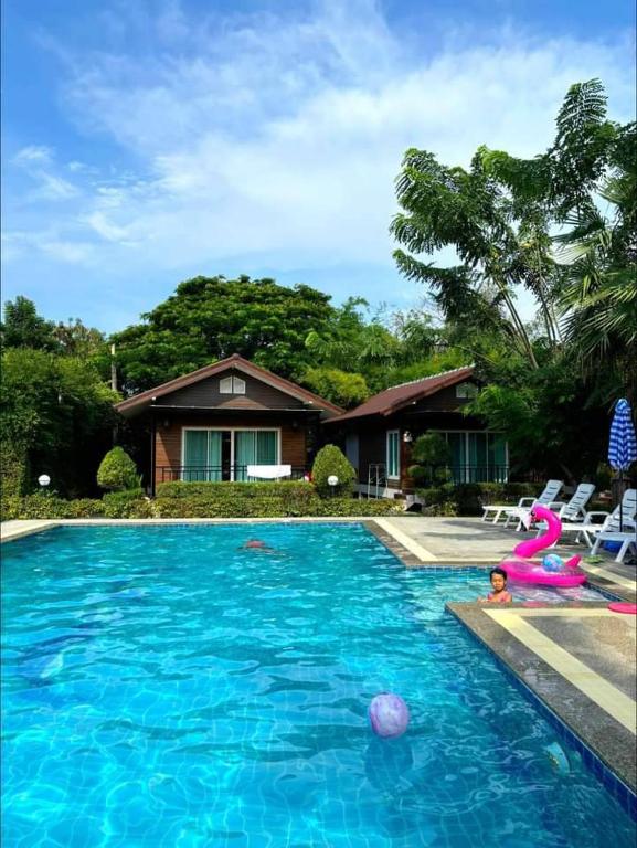 a swimming pool with a mermaid in the middle of it at Monmai Resort Huahin in Hua Hin