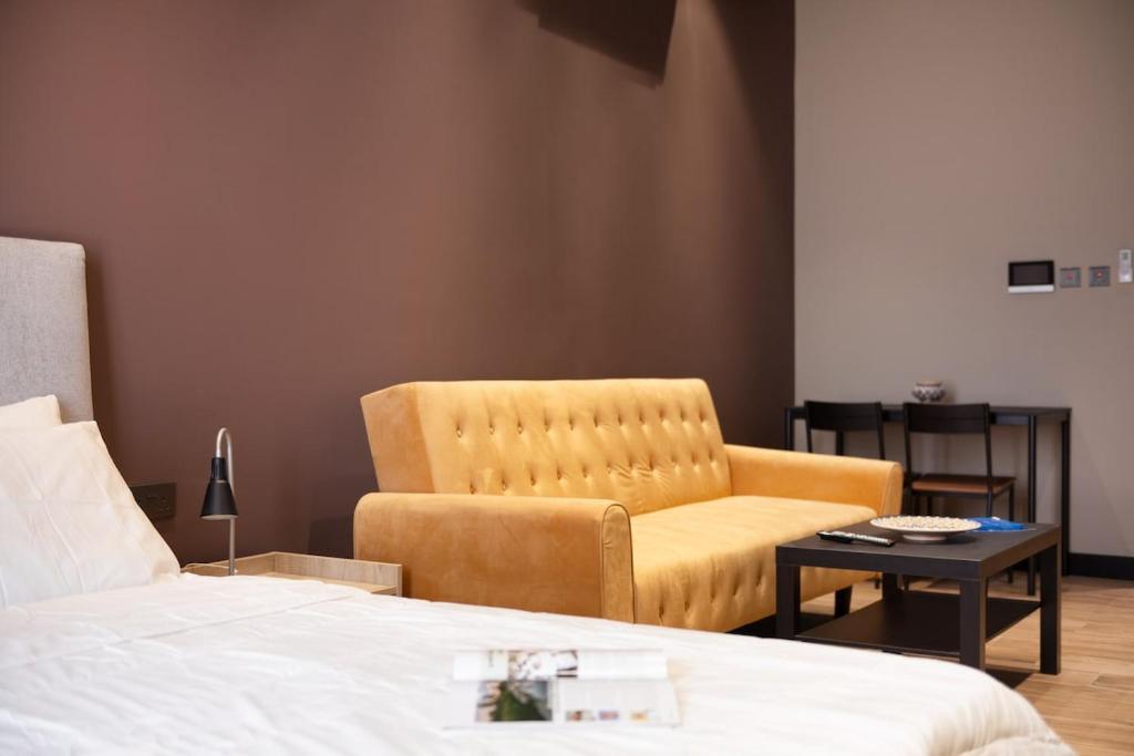 a bedroom with a bed and a chair and a table at Luxury home away Studio by Spacey Duqm 81 in Duqm