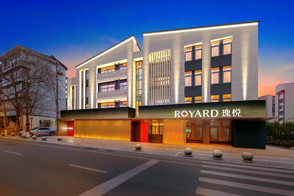 a tall white building with a sign on it at Rosewood Chengdu in Chengdu