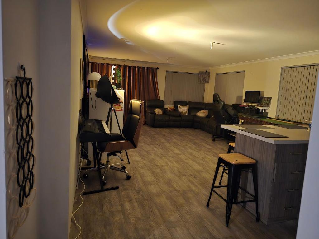 a living room with a couch and a table at Aragon Demi-Apartment Baldivis in Baldivis