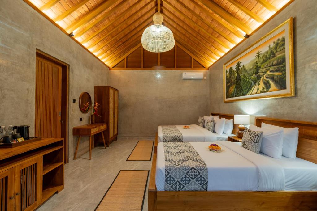 une chambre d'hôtel avec deux lits et une télévision dans l'établissement Duara Ubud Wooden Suite, à Ubud