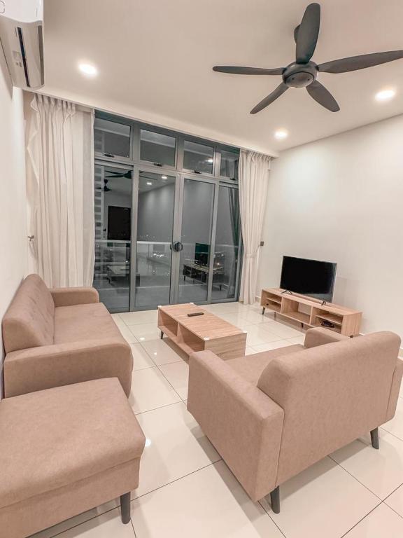 a living room with two couches and a flat screen tv at Starry B19 Green Haven 2BEDROOMS l NETFLIX in Masai