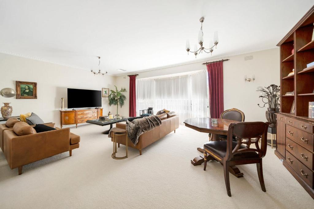 a living room with a couch and a table at Hunter House - Castlemaine in Castlemaine