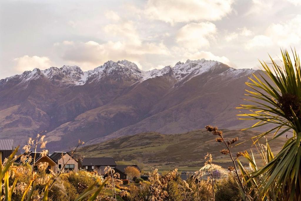 a mountain range with houses and mountains in the background at Modern Luxe Jacks Point Living in Queenstown Airport