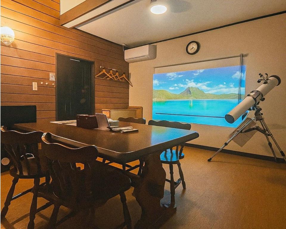 a dining room with a table and a telescope at THE LOOKOUT KUSATSU - Vacation STAY 90962v in Kusatsu