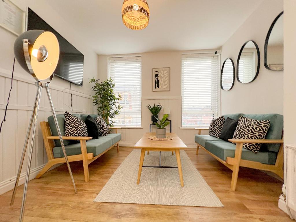 a living room with a couch and a table at Ocho Homes Lux By Eight Continents, Belfast in Belfast