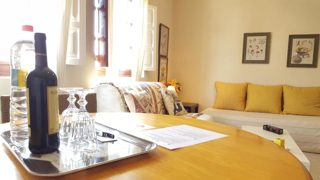 a bottle of wine on a table in a living room at Apartamento Maya in Las Lagunas