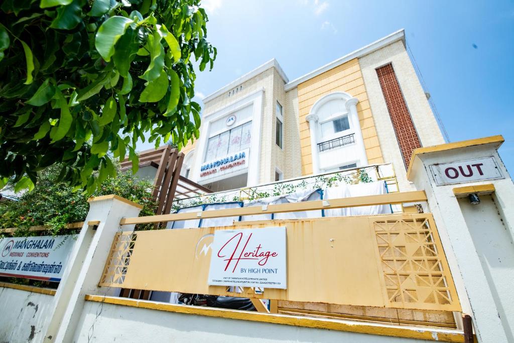 a building with a sign in front of it at Heritage By High Point in Tiruchchirāppalli