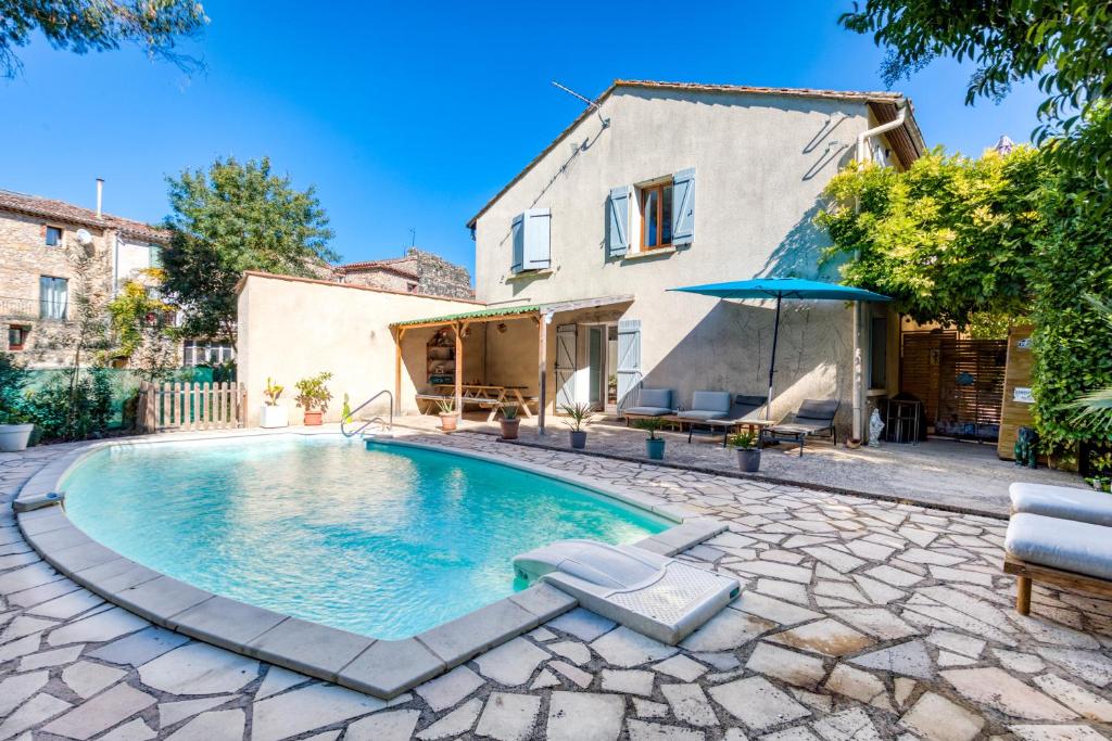 une piscine devant une maison dans l'établissement Maison Sur La Mare, à Villemagne