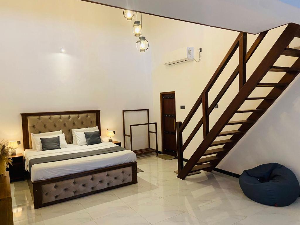 a bedroom with a bed and a staircase at Mountain Bliss - Ingiriya in Ingiriya