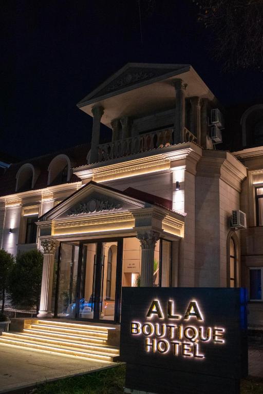 aania boutique hotel sign in front of a building at night at Ala Boutique Hotel in Almaty
