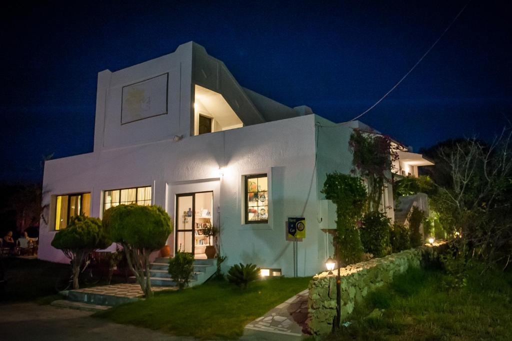 a white building with a clock on it at night at Ilios and Irene in Mastichari