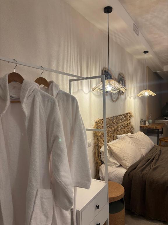 a bedroom with a bed and a rack with towels at Panta Rei 97 in Barletta