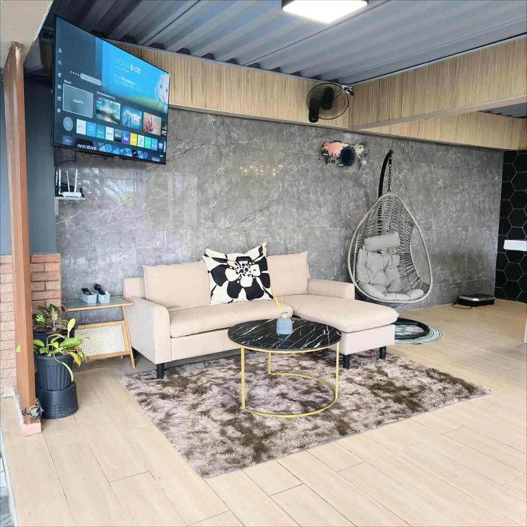 a living room with a couch and a table at Casa Andrea Bella in Bacolod