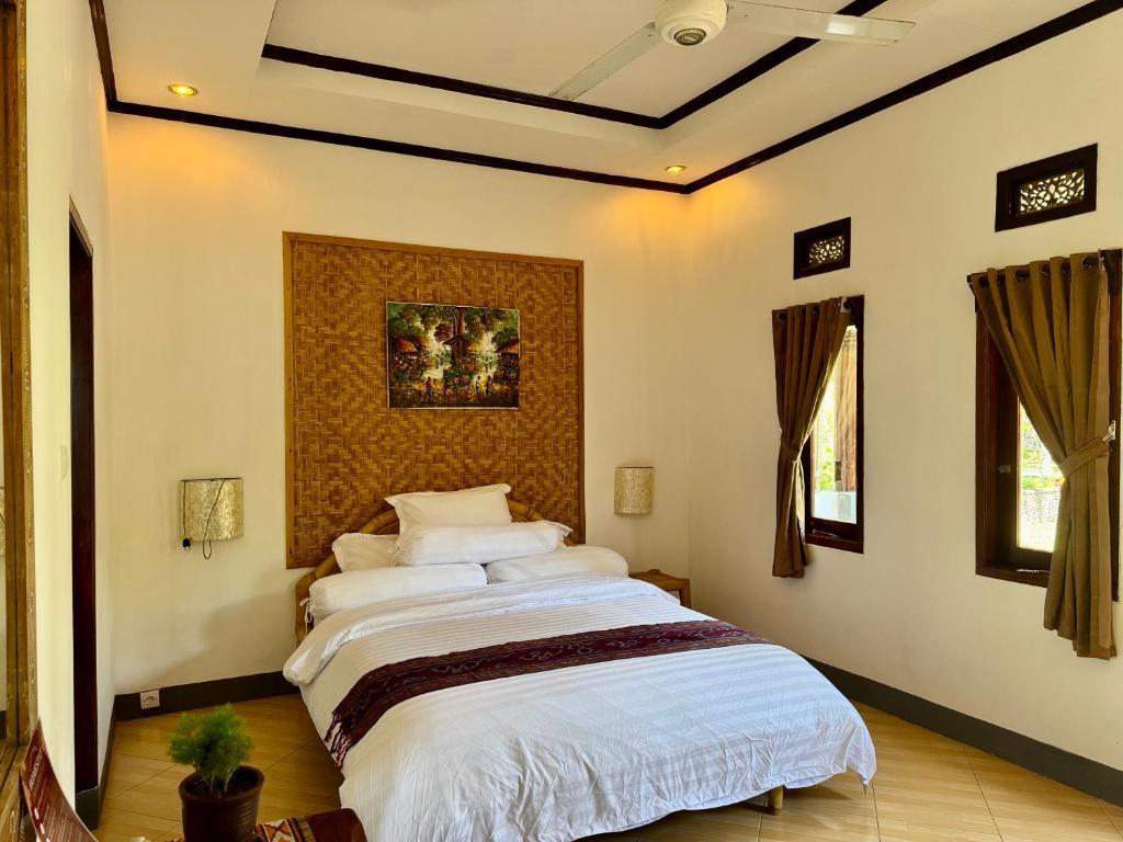 Ένα ή περισσότερα κρεβάτια σε δωμάτιο στο Sasak Garden Homestay