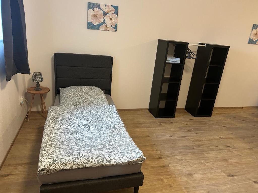 a room with two beds and a shelf at Haus Elbert Eschau in Eschau
