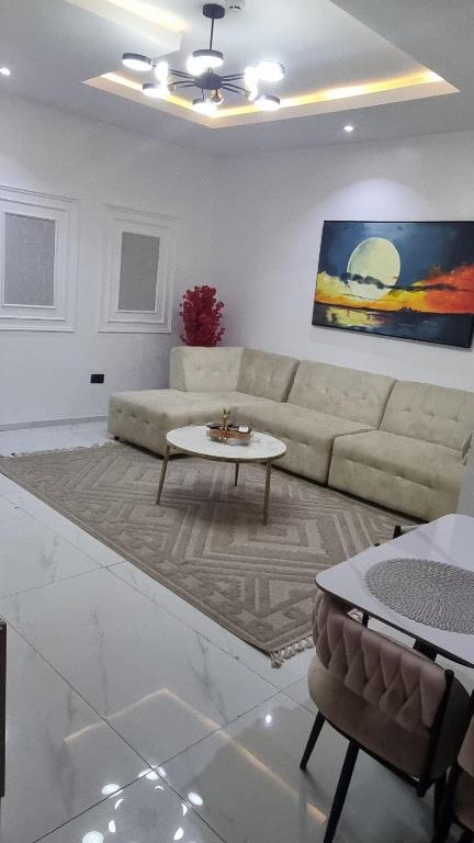 a living room with a couch and a table at Uranus Premium Apartments and Suites in Lagos