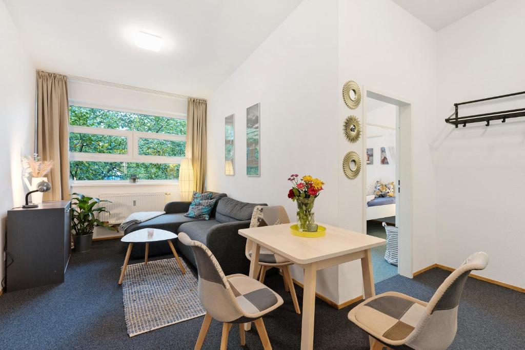 a living room with a couch and a table at Albrechtshof Apartment 3 in Neu Fahrland