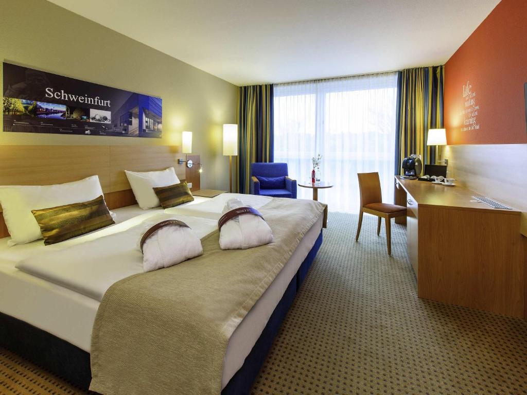 Postel nebo postele na pokoji v ubytování Mercure Hotel Schweinfurt Maininsel