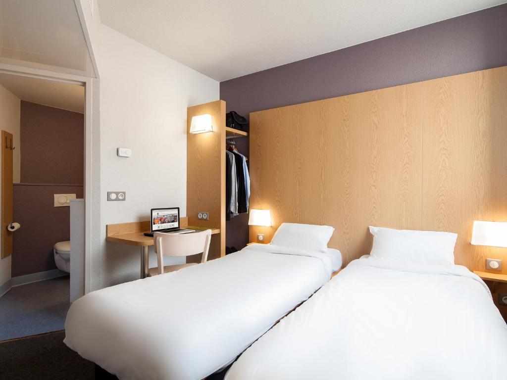 Postel nebo postele na pokoji v ubytování B&B HOTEL Montpellier Centre Le Millénaire