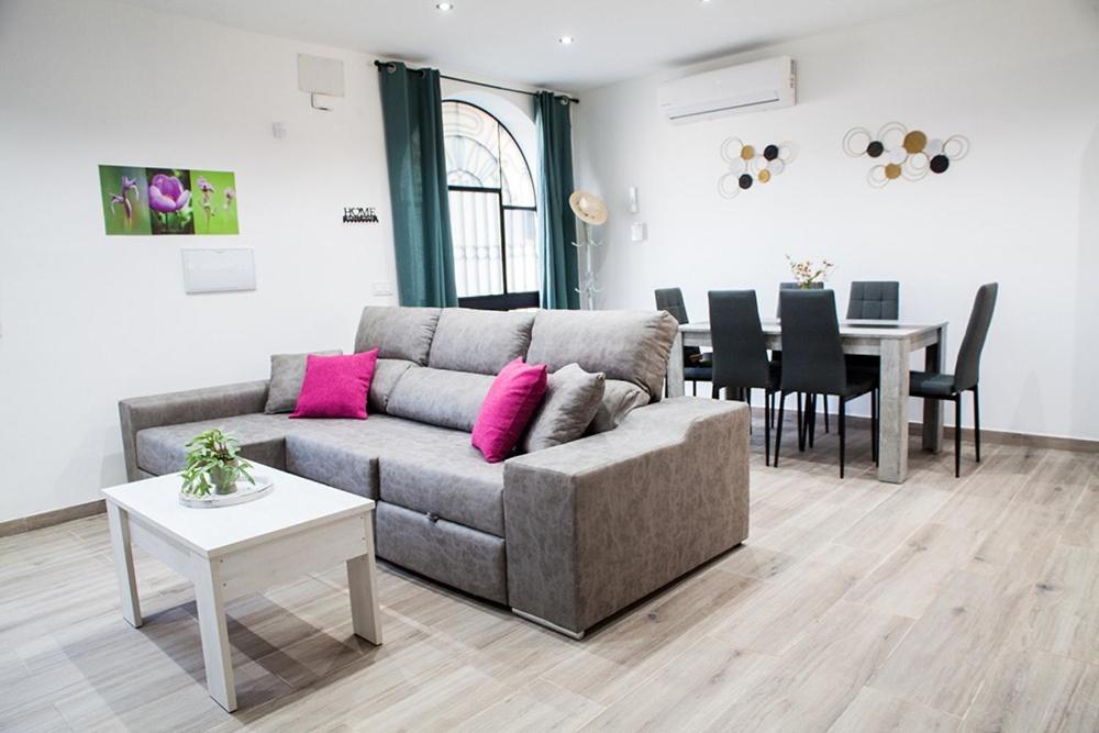 a living room with a couch and a table at Casa Molino San Antonio in Córdoba