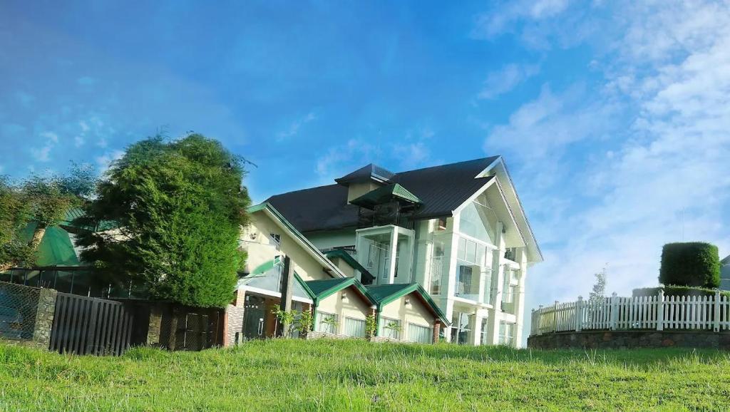 a large white house with a black roof at Oak Ray Misty Hills in Nuwara Eliya